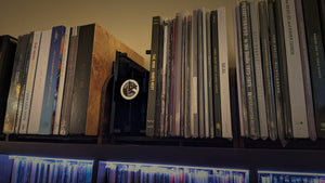 RecordStay positioned between boxed sets and vinyl records on a shelf.