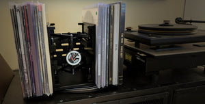 RecordStay keeping records upright beside a turntable.
