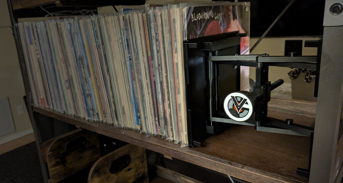 RecordStay supporting vinyl records on a wooden shelf.