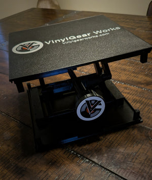Standalone RecordStay viewed at an angle, showing the branded platform and adjustment knob.