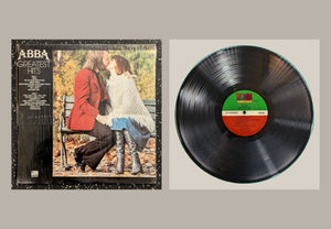 ABBA - Greatest Hits, actual copy, complete front cover alongside the matching full vinyl record with upright label and all edges visible