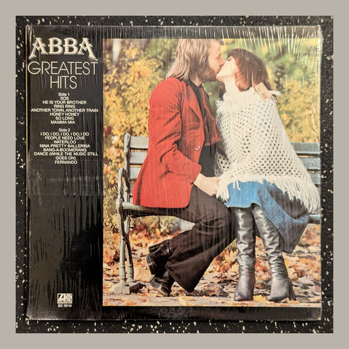 ABBA - Greatest Hits, actual copy, front: kissing couple; title column on left, complete physical edges visible in a matching light frame